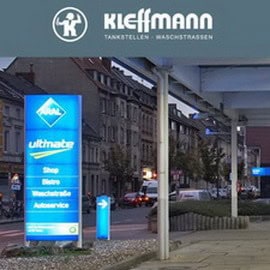 Tankstellen mit moderner Waschstraße in urbaner Umgebung.